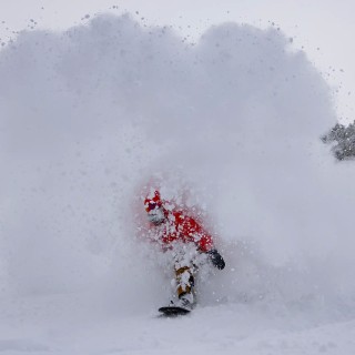 Rider Marcus Cassidy wears the Men's Shralpinist Stretch Recycled Jacket in Lava Red